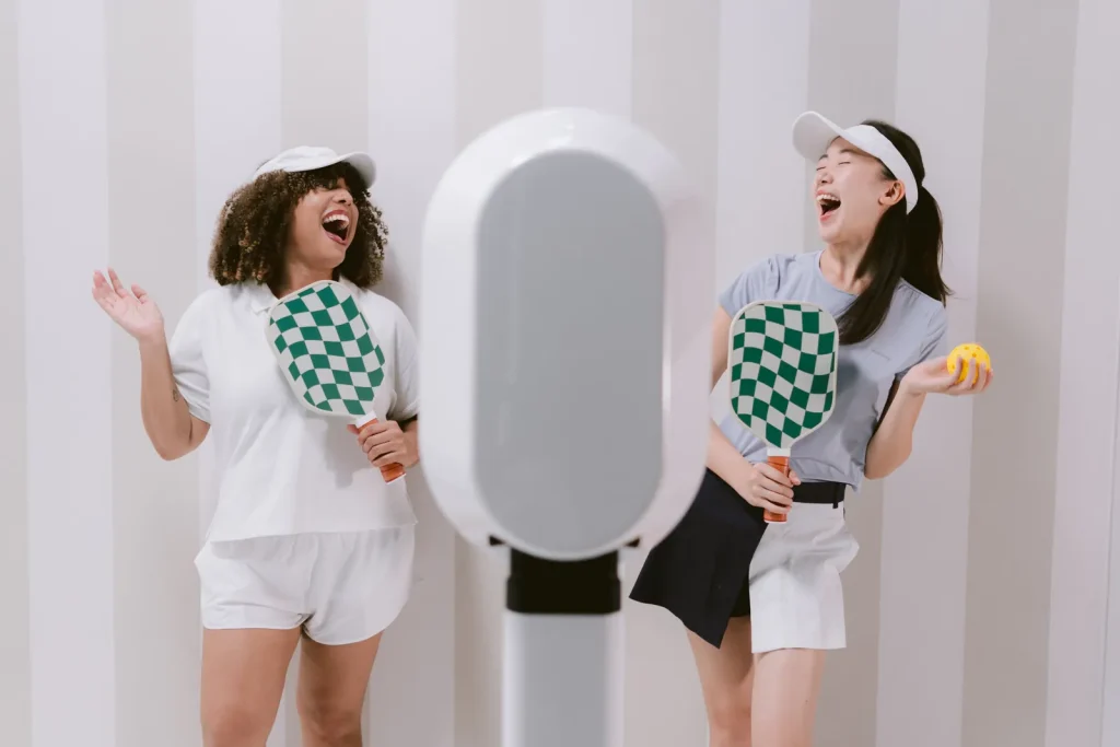 Two guests having fun beside the AIRi selfie photo booth