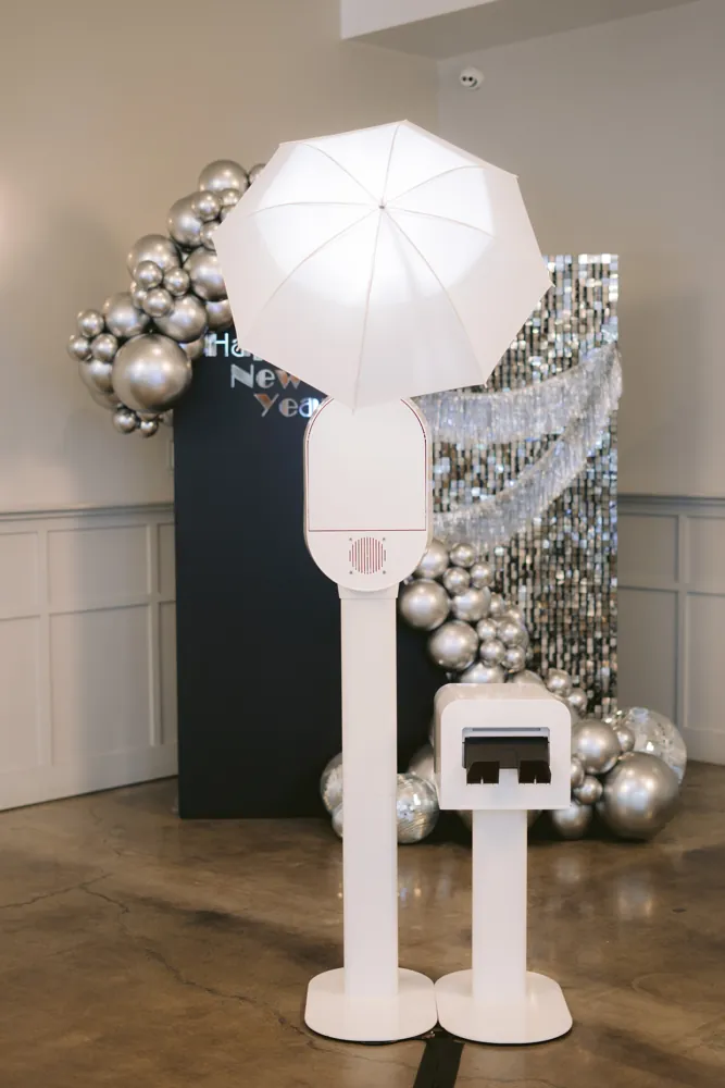 AIRi photo booth with ring light, umbrella strobe and printer at a New Year's party