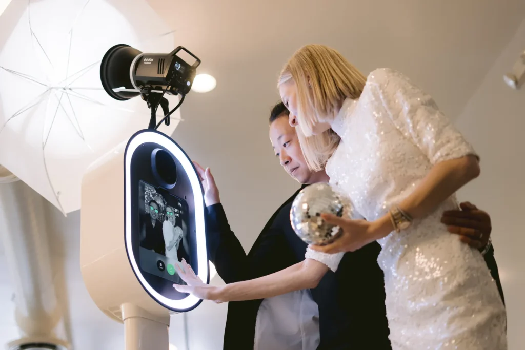 Guests using the AIRi photo booth touchscreen with ring light